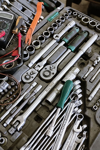 Detailed of various mechanic tools organized in a workshop setting. Perfect for repair themes. HD phone wallpaper