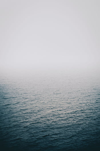 A calming view of a misty lake with tranquil blue waters, perfect for relaxation. HD phone wallpaper