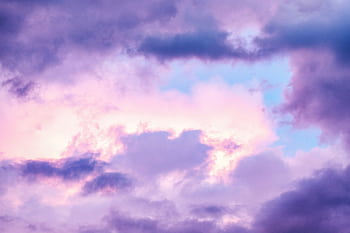 A serene sky with pastel-colored clouds creating a peaceful atmosphere. HD wallpaper