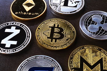 Detailed view of assorted cryptocurrency coins including Bitcoin, Ethereum, and Ripple. HD wallpaper