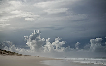 lone figure on cloud covered beach, sea, person, clouds, sky, beach HD wallpaper