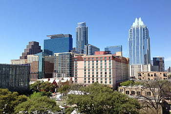 A vibrant daytime cityscape of downtown Austin, showcasing modern architecture and towering skyscrapers. HD wallpaper