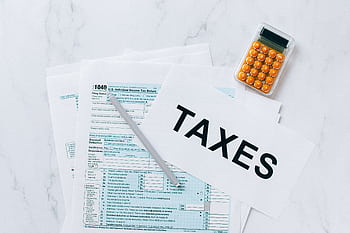 Top view of tax forms, a calculator, and pen for tax preparation. HD wallpaper
