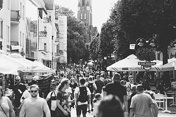 A black and white capturing a busy street filled with people in Sopot, Poland during the day. HD wallpaper