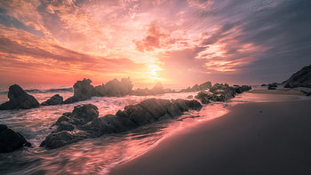 Rocks Stones On Ocean Waves Beach Sand Under Black Clouds Blue Sky During Sunset Nature HD wallpaper