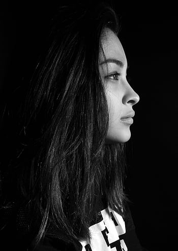 Black and white side profile of a woman with long hair against a dark background. HD phone wallpaper
