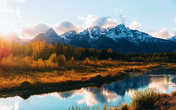 Late evening sun setting over the Teton Range, Wyoming, autumn, trees, snake river, water, mountains, usa, reflections HD wallpaper