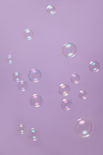 Floating soap bubbles against a serene lilac background emphasize purity and playfulness. HD phone wallpaper