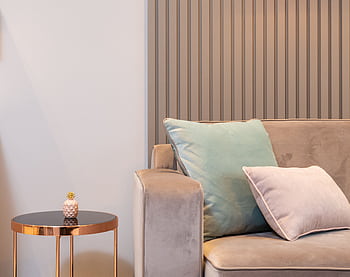 Elegant living room interior with soft cushions and modern decor elements for a cozy ambiance. HD wallpaper