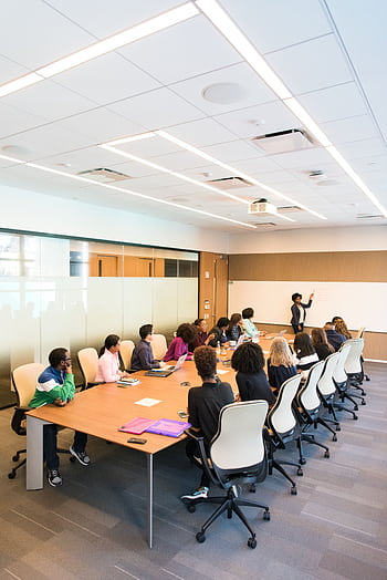 Professional team engaged in a collaborative boardroom meeting with a presentation in progress. HD phone wallpaper