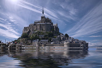 A que view of the historic Mont Saint-Michel reflecting in the water under a bright sky. HD wallpaper