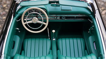 Vintage Mercedes car interior featuring green seats and dashboard, highlighting classic automotive design. HD wallpaper