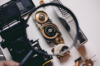 Intricate gears of a camera mechanism magnified, showcasing mechanical precision. HD wallpaper
