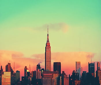 Colorful sunset view of New York City skyline featuring the iconic Empire State Building. HD wallpaper