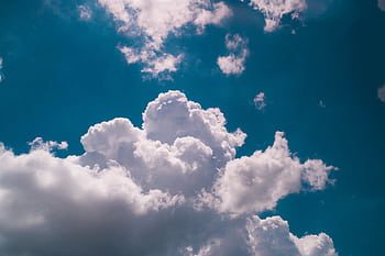 Beautiful fluffy clouds against a vibrant blue sky in Bahia, Brazil, showcasing nature's drama. HD wallpaper