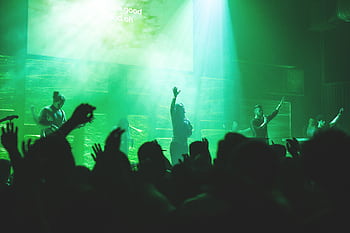 Dynamic church worship concert with a band performing on stage, creating a vibrant atmosphere. HD wallpaper