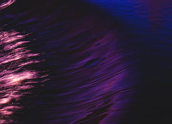 Swirling abstract art with vibrant purple and pink reflections in water, evoking a sense of motion and flow. HD wallpaper