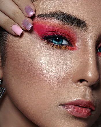 Close-up of a woman with bold makeup; featuring pink eyeshadow and blue eyes. HD phone wallpaper