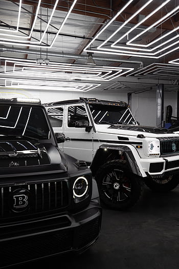 Luxury Mercedes Benz cars parked indoors with sleek lighting reflections. HD phone wallpaper