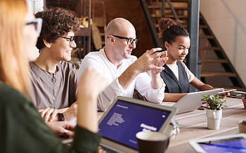 A diverse group of professionals engaging in a collaborative brainstorming meeting. HD wallpaper
