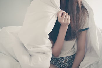 Cozy morning scene with a young woman relaxing under a blanket. HD wallpaper