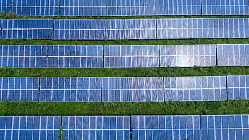Aerial shot of a solar panel array generating renewable energy in Trenton, Georgia. HD wallpaper