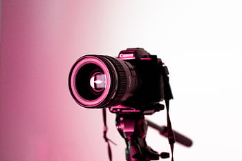 Canon DSLR camera with lens on tripod in studio lighting, perfect for graphy enthusiasts. HD wallpaper