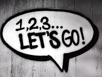 Black and white street art featuring a bold motivational message in a speech bubble. HD wallpaper