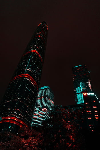 Vibrant illuminated skyscrapers in Guangzhou captured at night, showcasing modern architectural marvels in a stunning cityscape. HD phone wallpaper
