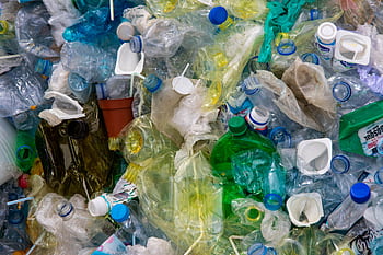 Pile of assorted plastic waste highlighting recycling and sustainability efforts. HD wallpaper
