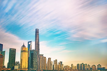 Shanghai skyline featuring iconic skyscrapers against a colorful dawn sky. Ideal for urban and architecture themes. HD wallpaper