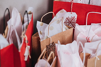 Collection of festive shopping bags filled with holiday gifts. HD wallpaper
