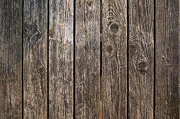 Close-up of weathered wooden planks showcasing unique texture and grain patterns. HD wallpaper