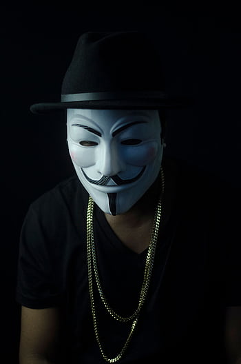 Portrait of a person in a Guy Fawkes mask and fedora, exuding mystery. HD phone wallpaper