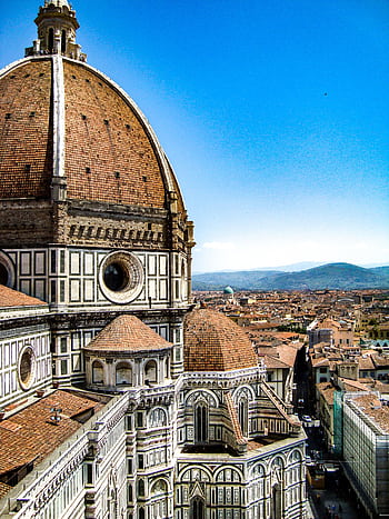 Iconic view of Florence Cathedral's dome against a clear Tuscan sky, a masterpiece of Renaissance architecture. HD phone wallpaper