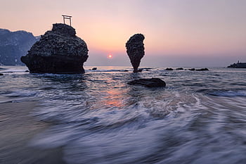 Dramatic ocean landscape with unique rock formations and sunset view. HD wallpaper