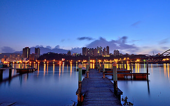 City Lights, pier, peaceful, sunrise, beauty, buildings, reflection, ocean, sea, architecture, city, beautiful, lights, building, view, clouds, nature, sky, lovely, splendor HD wallpaper