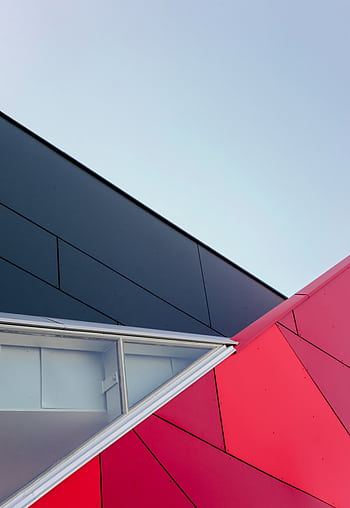 A low-angle view of a modern geometric building facade with bold colors in London, ON, Canada. HD phone wallpaper