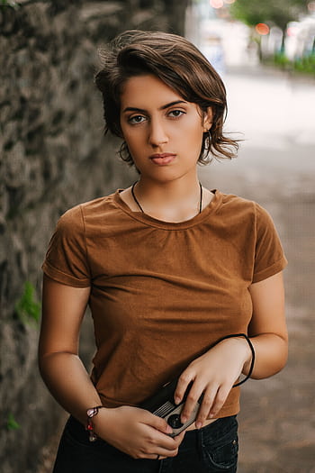 Portrait of a fashionable young woman standing outdoors in São Paulo, Brazil. HD phone wallpaper