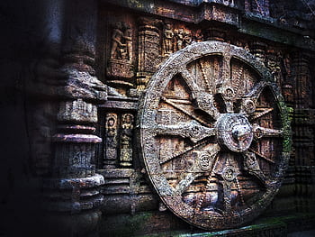 Intricate stone carving of a chariot wheel at the historic Konark Sun Temple, India. HD wallpaper