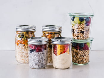 Close-up of healthy food jars containing granola, fruits, and yogurt. HD wallpaper
