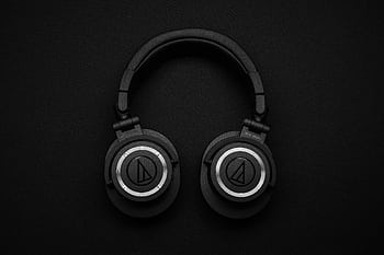 Close-up of black over-ear heads on a black background, showcasing modern design. HD wallpaper