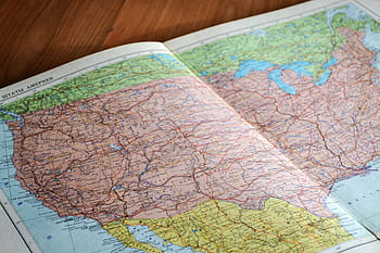 High-angle view of a vintage map depicting the United States with intricate details. HD wallpaper