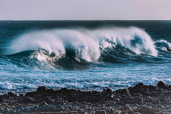 Captivating of ocean waves crashing against the rocky shore of Lanzarote, Spain. HD wallpaper