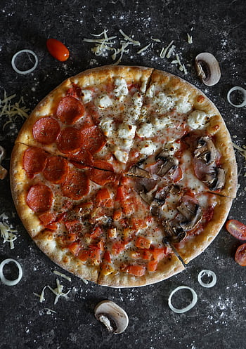 Top view of a homemade pizza with assorted toppings, perfect for a savory meal. HD phone wallpaper