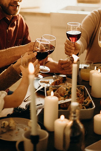 Warm family dinner scene with wine toasting and candlelight ambiance for a festive celebration. HD phone wallpaper