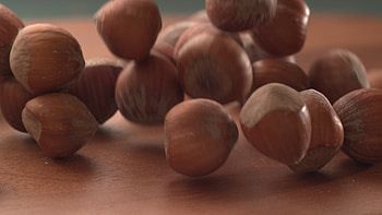 Slow motion video, Falling hazelnuts, Wooden surface, High-speed capture HD wallpaper