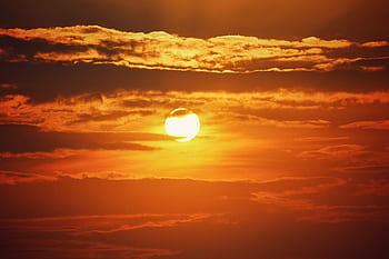 A breathtaking golden sunset with dramatic clouds in Thrissur, India. HD wallpaper