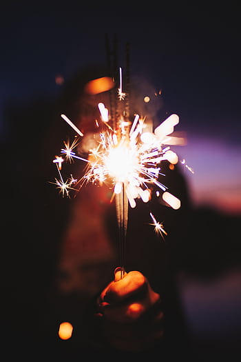 Vibrant sparkler lighting up the night, creating a festive atmosphere in São Paulo, Brazil. HD phone wallpaper