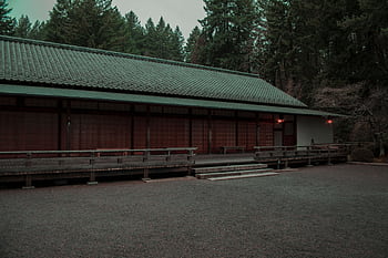 A peaceful Japanese-style building surrounded by lush trees in Portland, Oregon creates a serene atmosphere. HD wallpaper
